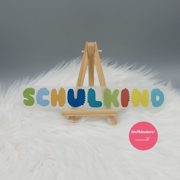 "Schulkind" bunt Bügelbild (ca. 23,5cm x 3cm)